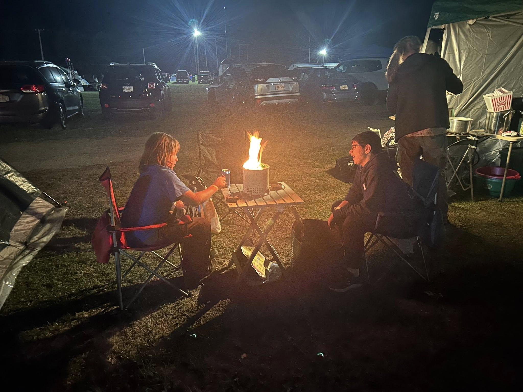 Troop 54 Scouts sitting around a campfire at night