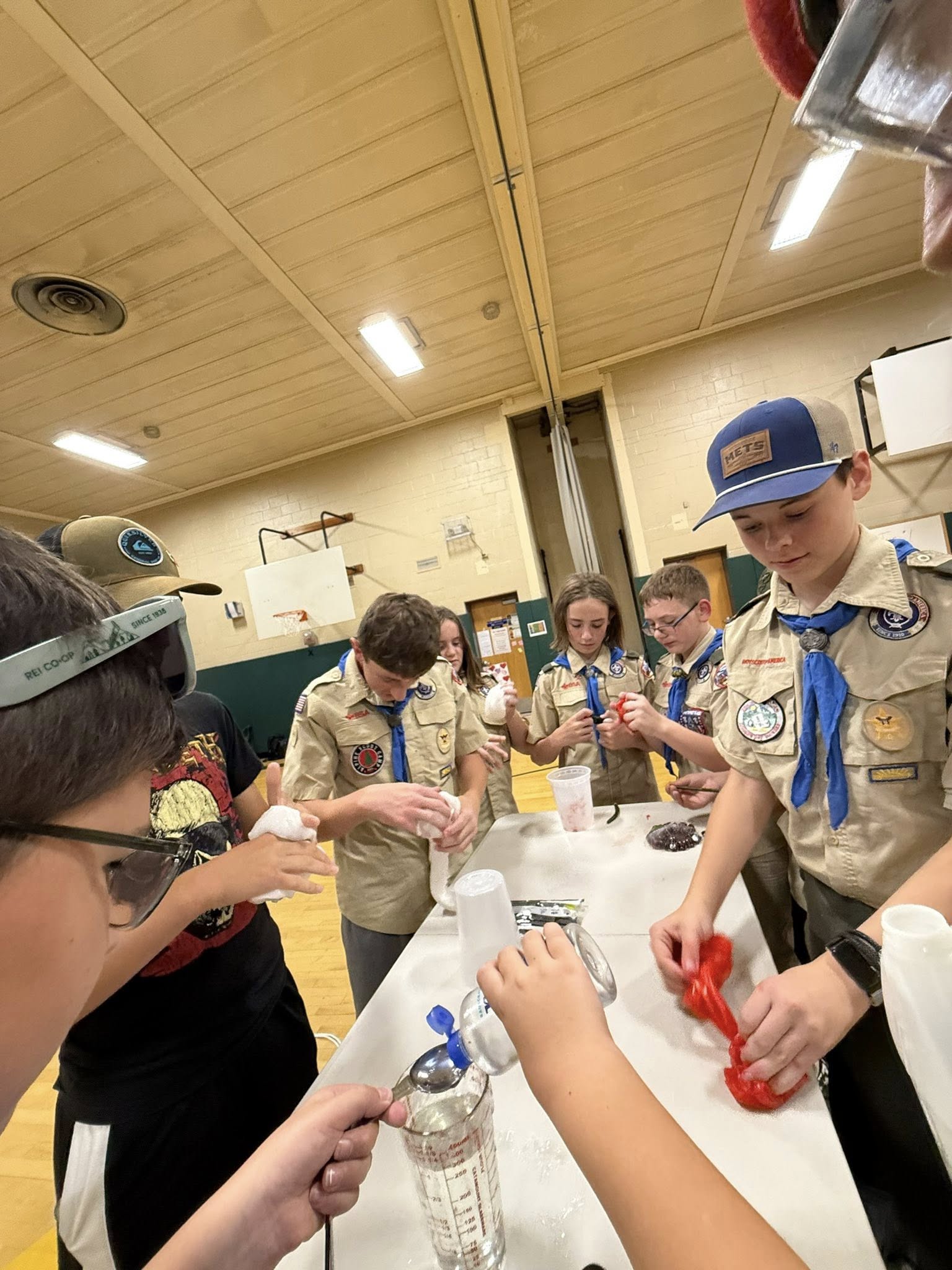 Scouts making slime during a fun troop meeting activity