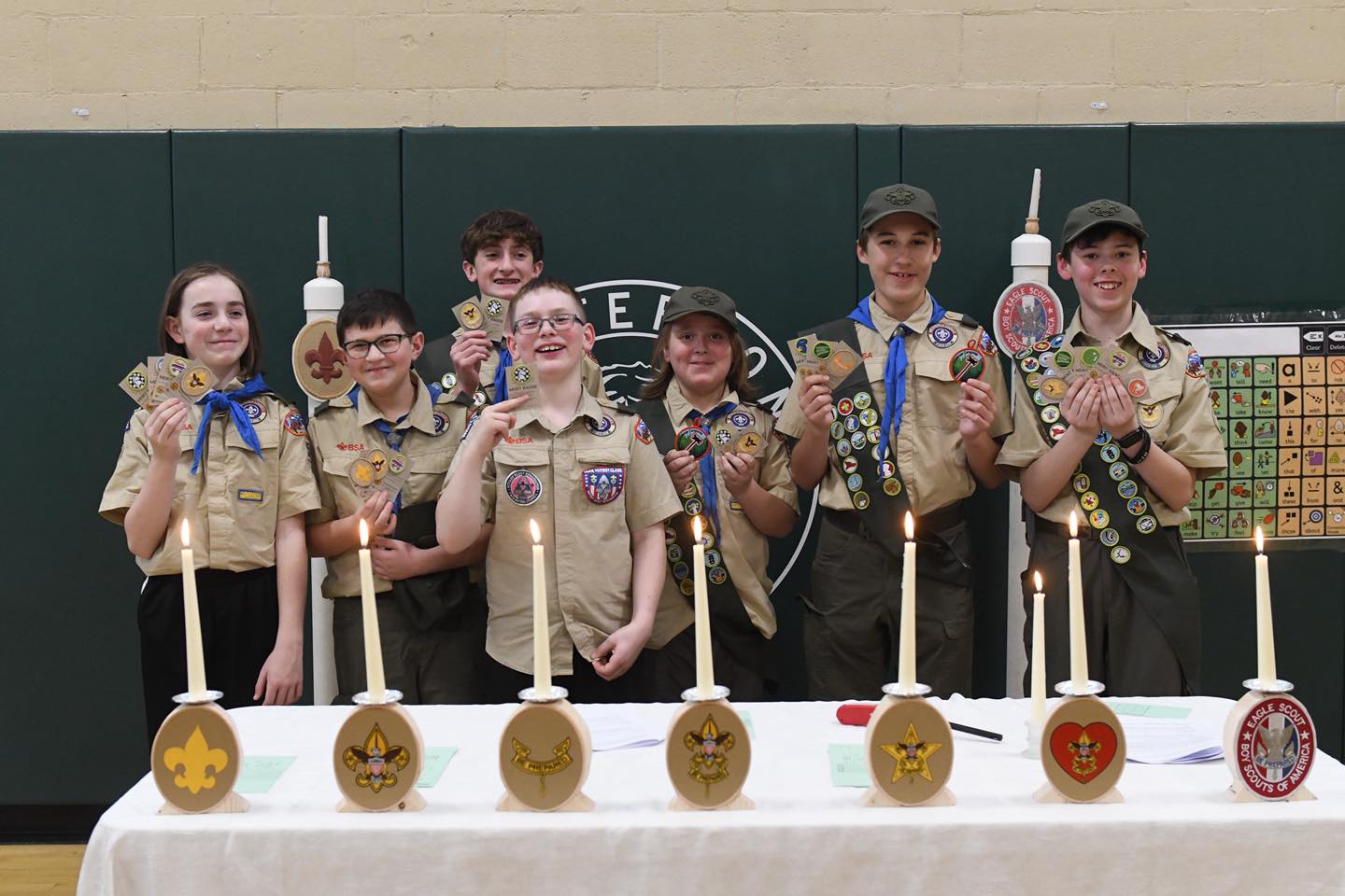 Troop 54 Scouts at a Court of Honor ceremony with rank candles and merit badge sashes